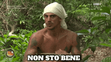 a shirtless man with a white bandana on his head says non sto bene