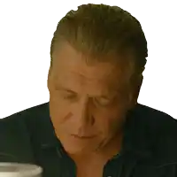 a man in a denim shirt has his eyes closed