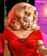 a woman in a red dress is sitting on a pink couch with t4yce tumblr in the corner