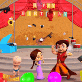 a happy birthday banner hangs over a stage with cartoon characters