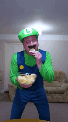 a man in a luigi costume is eating a chip