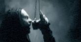 a man with dreadlocks is holding a chain in his hands .
