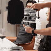 a man is holding a clapper board that says lol