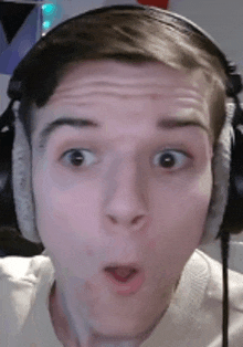 a man wearing headphones is making a funny face .