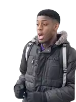 a young man wearing a black jacket and a backpack with the word tommy on it