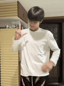 a person wearing a white shirt and black pants with lightning bolts on them is dancing
