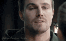 a close up of a man 's face with felicity and heroliver tumblr written in the corner