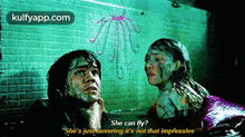 a man and a woman are looking up at a drawing on a wall and the woman is asking if she can fly