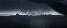 a person is flying through the air in a dark room with a light coming out of the sky .