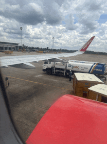 a skypec truck is parked next to an airplane on the tarmac