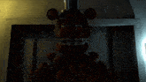 a teddy bear with a top hat and bow tie is standing in a dark room