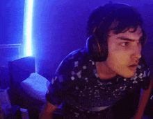 a man wearing headphones and a shirt that says ' a ' on it