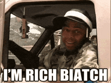 a man in a truck with the words i 'm rich biatch on the side