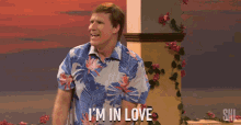 a man in a hawaiian shirt says i 'm in love in front of flowers