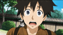 a close up of a boy 's face with a surprised look on his face