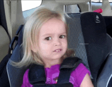 a little girl sitting in a car seat with faked humor written below her