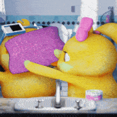 a yellow rubber duck with a pink bow on its head is holding a purple towel