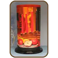 a candle holder with a picture of apples and candles