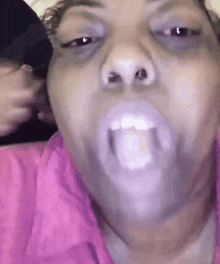 a close up of a woman making a funny face with her mouth open