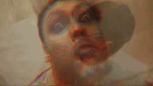 a close up of a man 's face with a rainbow of colors