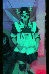 a person dressed as a skeleton in a maid costume is standing in a room .