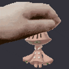 a pixelated image of a hand holding a small pink doll