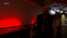 a man and a woman are walking in a dark room with aaw written on the bottom