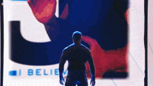 a silhouette of a man standing in front of a screen that says i believe