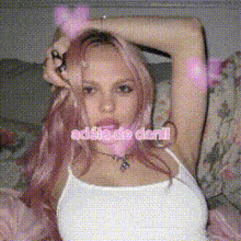 a woman with pink hair is laying on a couch with the words addia de dani on her face