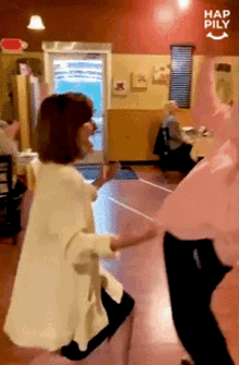a group of people are dancing in a room with the words hap pily written on the bottom