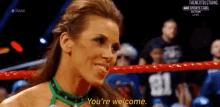 a woman in a wrestling ring says you 're welcome