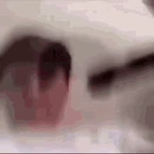 a close up of a person 's face with a blurred background .