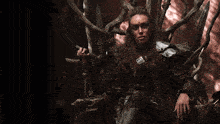a woman is sitting on a throne holding a sword