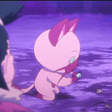 a pink cartoon cat is holding a blue object