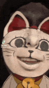 a tiktok video of a cat with a bell around its neck .