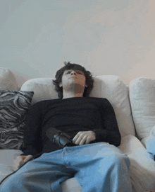 a man is laying on a couch with his head down