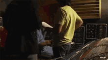 a man in a green shirt is talking to another man in a blue shirt