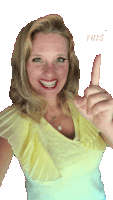 a woman in a yellow top is smiling and pointing up