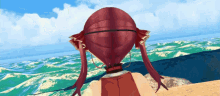 a girl with red hair is standing on a beach looking at the ocean