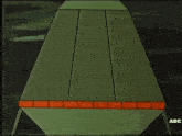 a cartoon drawing of a green object with the letters adc on the bottom right