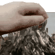 a close up of a person 's hand holding a piece of metal .