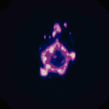 a purple and blue glowing object on a dark background .