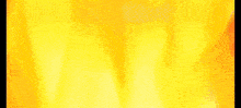 a blurry picture of a fire with a yellow and orange background .
