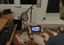 a man is playing a game on a keyboard with a screen that says ' x ' on it