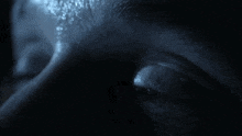 a close up of a person 's eye with a blue light shining on it