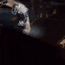 a man in a pirate costume is dancing on a stage in a dark room