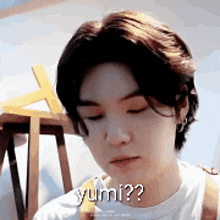a close up of a person 's face with the words `` yumi ? '' written on it .