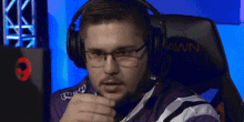 a man wearing glasses and headphones is sitting in a chair that says lawn