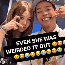 a man and a woman are posing for a picture with a sign that says even she was weirded tf out