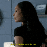 a woman in a black shirt says and he better vote for me